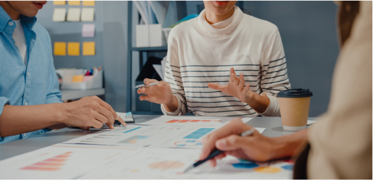 NEW BUSINESS START UP LOAN - photo graphics people talking charts lied on the table