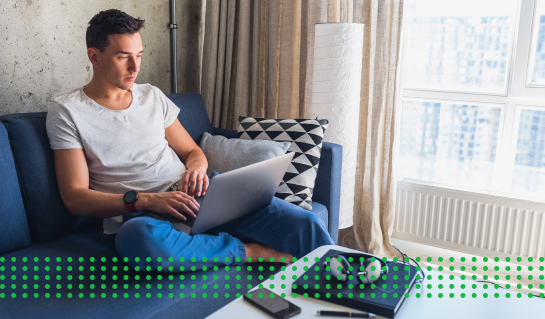 BUSINESS LOANS: EVERYTHING YOU NEED TO KNOW - photo graphics man sitting on couch holding laptop