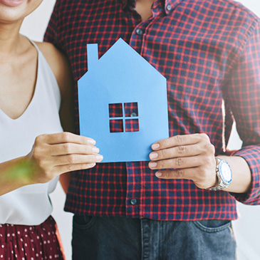 HOUSING LOAN - photo graphics man and woman holding house cut out