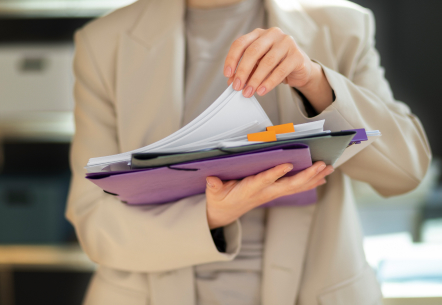 APPLY FOR A STARTUP LOAN - photo graphics person holding files and clipboard