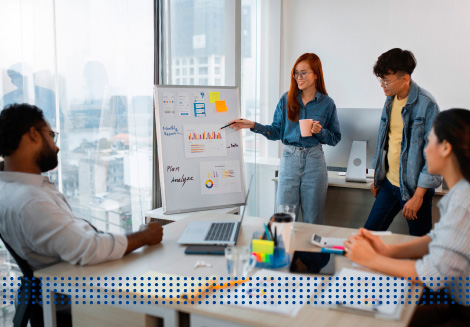 GET STARTUP BUSINESS FUNDING - photo graphics woman holding a cup pointing at whiteboard people listening