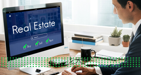 THE REAL ESTATE MARKET IN 2024 - photo graphics man sitting at desk looking at laptop