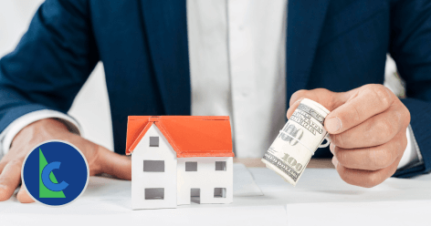 investment property - photo graphics man holding roll of dollar bills small house module